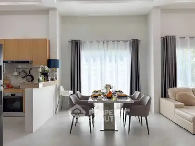 Modern dining area with elegant table setting and natural light in a stylish open-plan kitchen and living room.