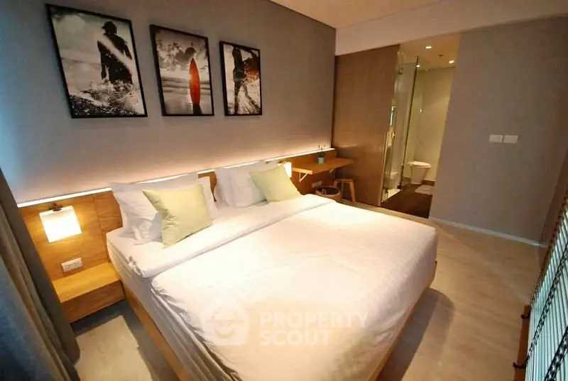 Modern bedroom with stylish decor and en-suite bathroom in luxury apartment.