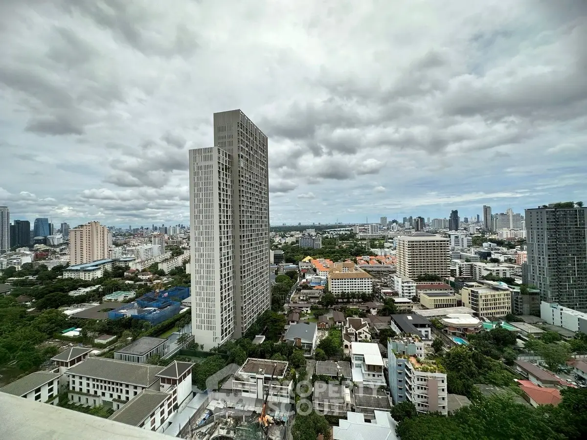Stunning cityscape view with modern high-rise buildings under a cloudy sky.