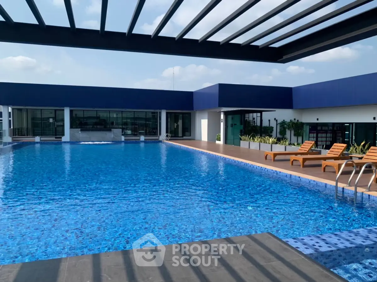 Luxurious rooftop pool with modern design and sun loungers, perfect for relaxation and leisure.