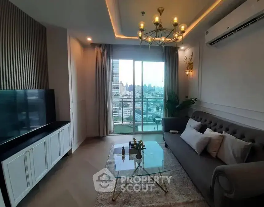 Luxurious living room with city view, elegant chandelier, and modern decor.
