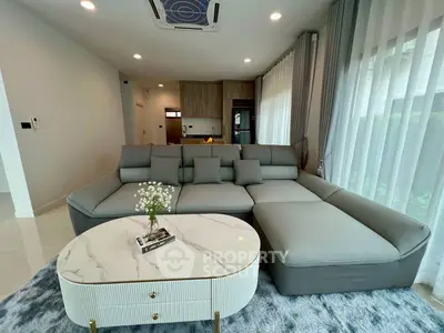 Luxurious living room with modern gray sectional sofa and elegant marble coffee table.