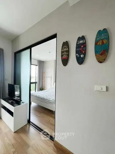 Modern bedroom with sliding glass door and stylish decor in a cozy apartment.