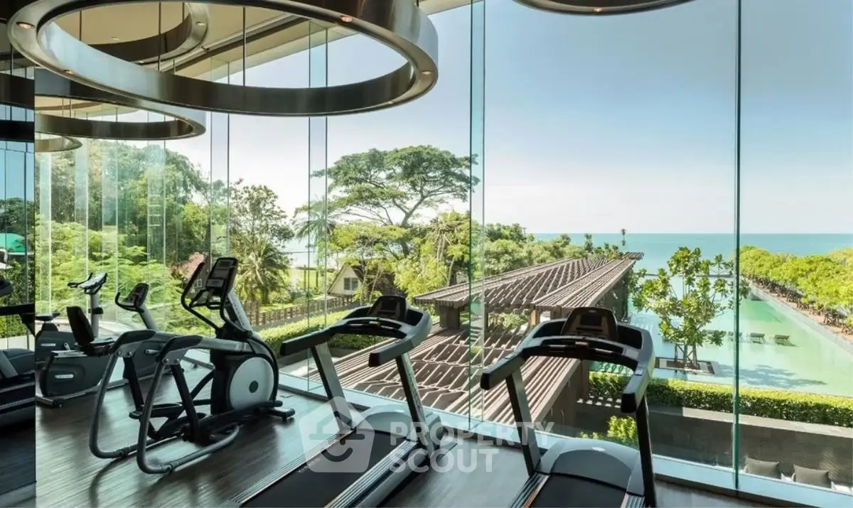 Luxurious gym with panoramic ocean view and modern equipment