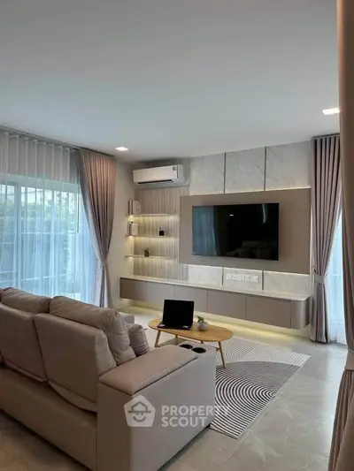 Modern living room with sleek design, large windows, and stylish furniture, perfect for relaxation and entertainment.