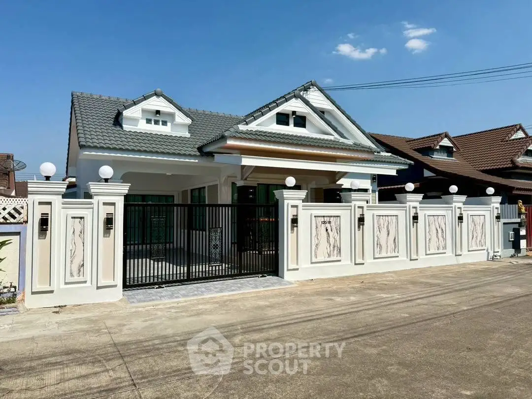 Charming single-story house with modern facade and gated entrance