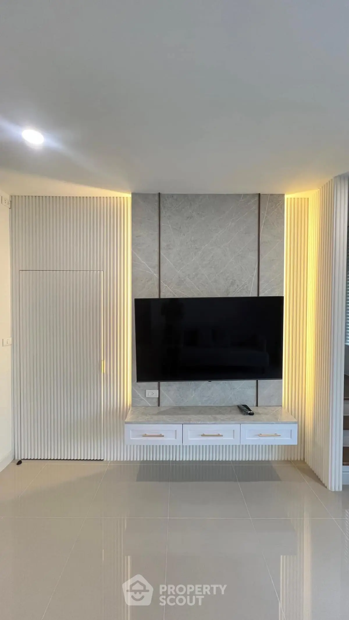 Modern living room with sleek TV wall unit and ambient lighting