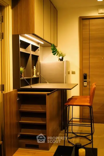 Modern kitchen with sleek cabinetry and breakfast bar in cozy apartment