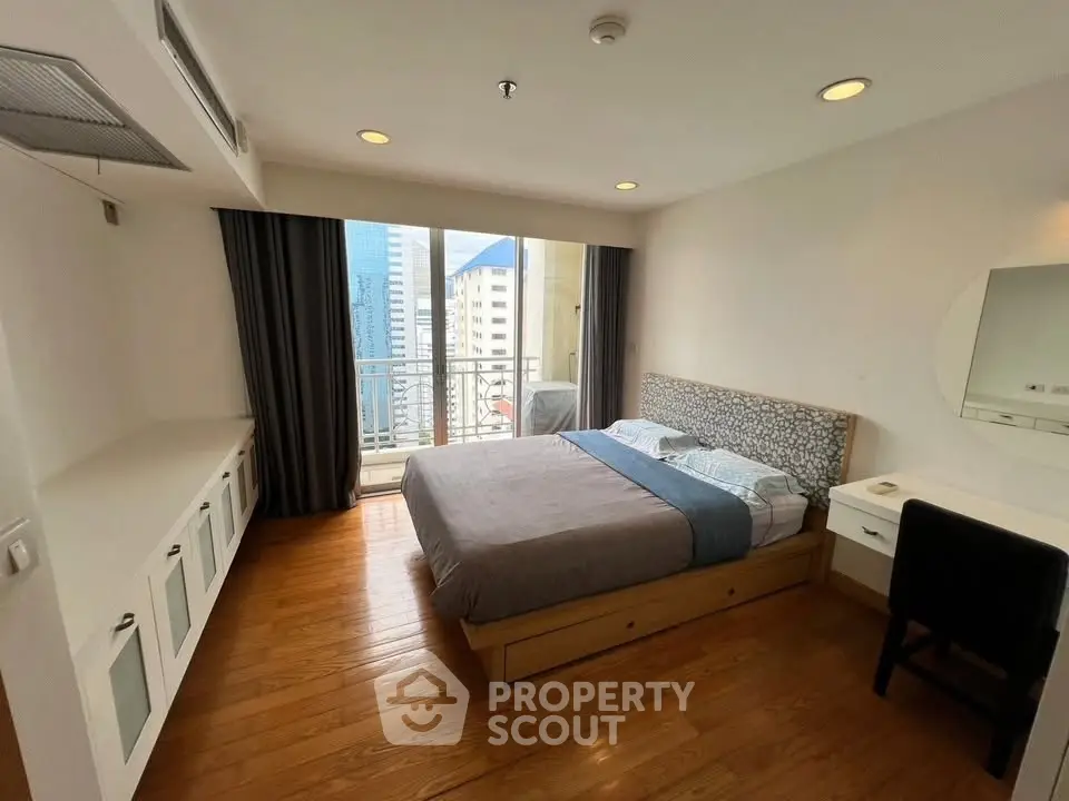 Spacious bedroom with city view and modern furnishings