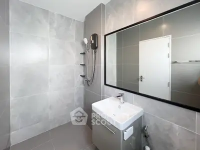 Modern bathroom with sleek gray tiles and a stylish vanity unit.