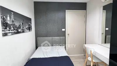 Cozy bedroom with modern decor and cityscape artwork, ideal for urban living.