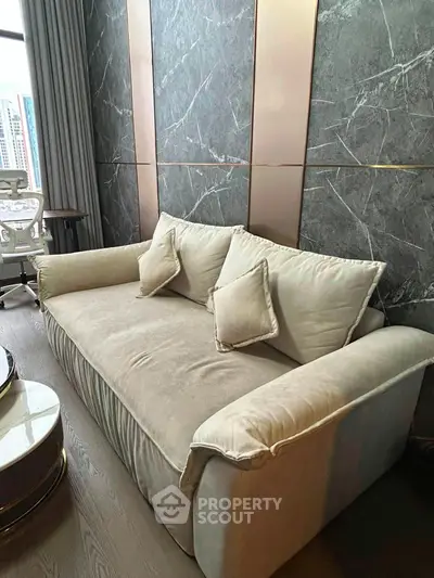 Luxurious modern living room with elegant marble walls and plush sofa, perfect for urban living.