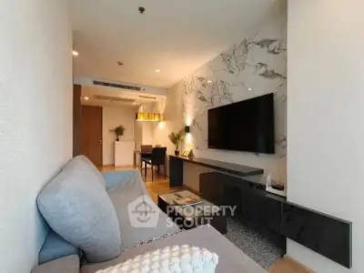Modern living room with stylish decor and wall-mounted TV in a cozy apartment.