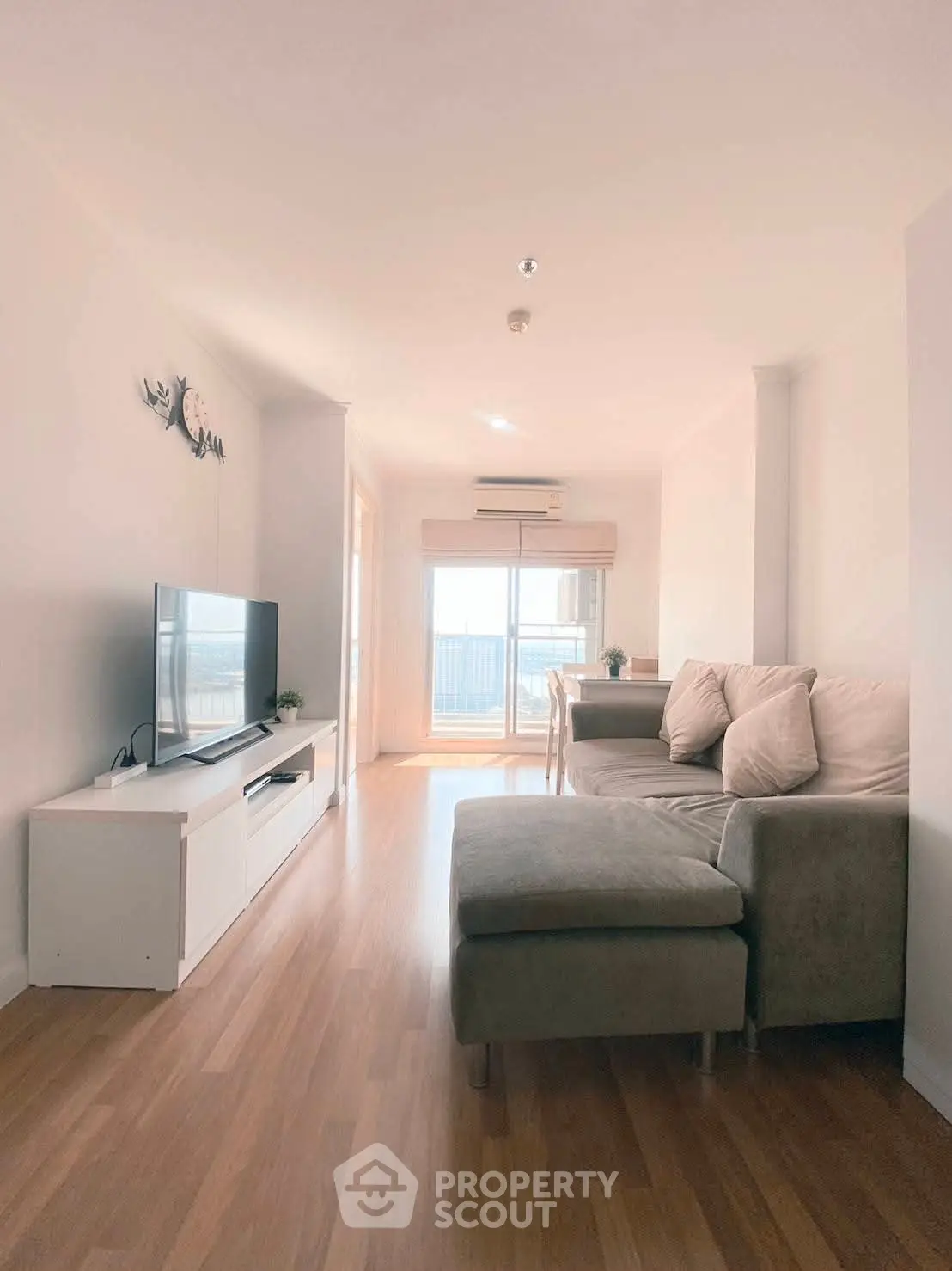 Bright and airy living room with modern decor and balcony access.