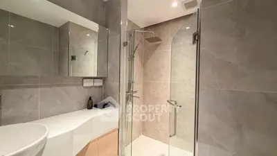 Modern bathroom with sleek glass shower and elegant tile design