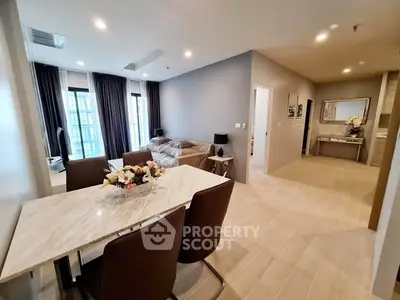 Modern open-plan living and dining area with elegant decor and natural light.