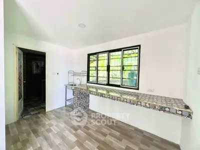 Bright kitchen with tiled countertop and large window view