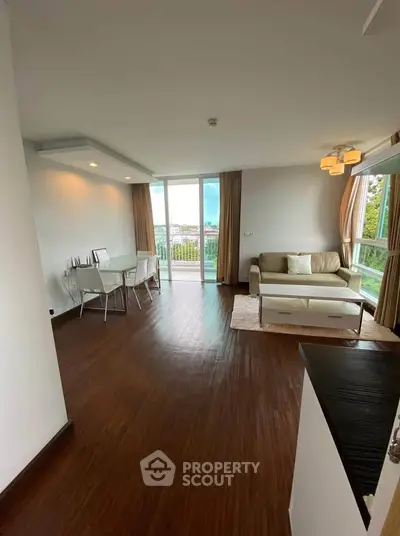 Spacious living room with modern decor and large windows offering a scenic view.