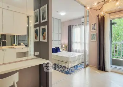Modern bedroom with balcony access and stylish decor in a contemporary apartment.