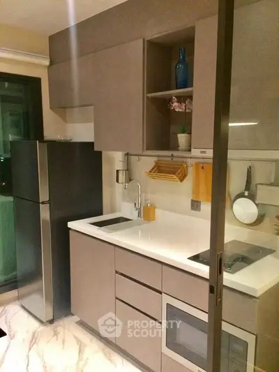 Modern compact kitchen with sleek cabinetry and stainless steel appliances