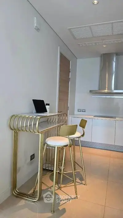 Modern kitchen with sleek bar stools and stainless steel appliances
