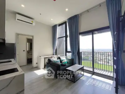 Modern living room with balcony and panoramic view, featuring sleek furniture and natural light.