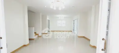 Spacious open-plan living area with modern lighting and glossy floors.