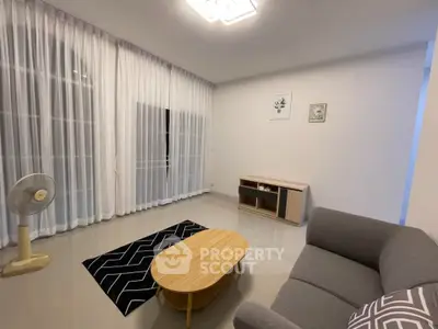 Modern living room with sleek furniture and large windows