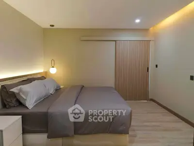 Modern bedroom with cozy lighting and sleek sliding door design