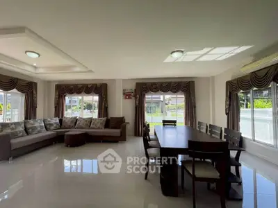 Spacious living room with elegant dining area and large windows for natural light.