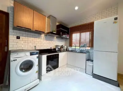 Modern kitchen with sleek appliances and stylish cabinetry in a contemporary home.