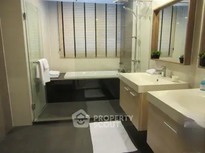Modern bathroom with sleek fixtures and large bathtub, perfect for relaxation.