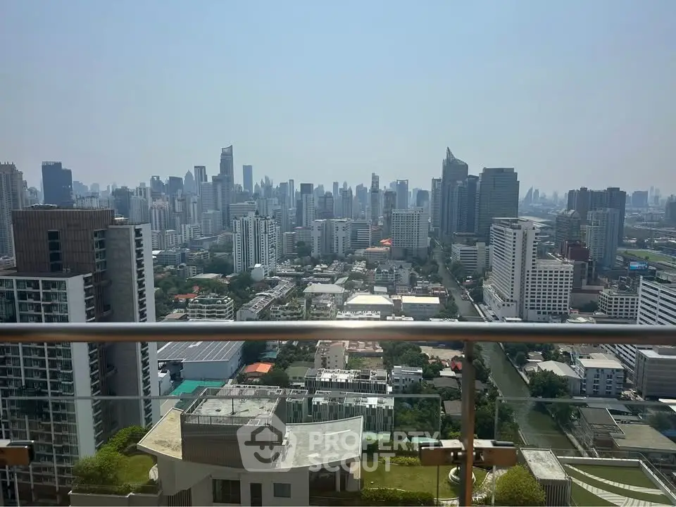 Stunning cityscape view from a high-rise balcony showcasing urban skyline and modern architecture.