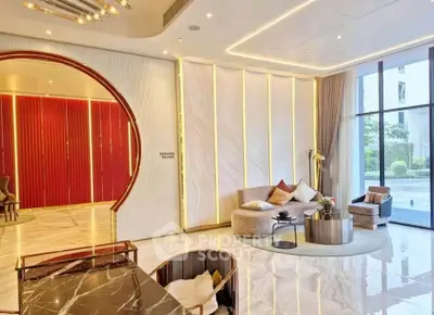 Luxurious modern living room with elegant decor and large windows offering natural light.