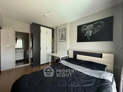 Modern bedroom with stylish decor and ensuite bathroom in a contemporary apartment.