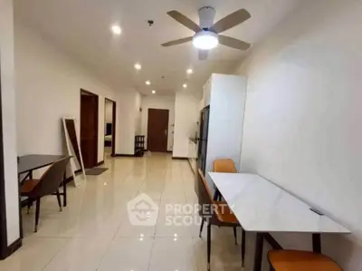 Spacious modern apartment interior with dining area and ceiling fan, perfect for comfortable living.