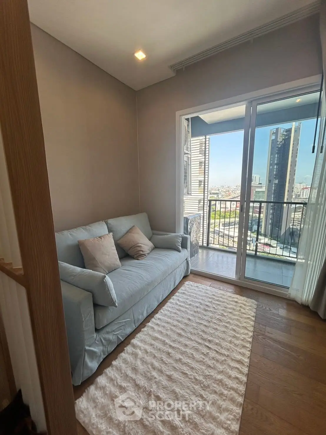 Cozy living room with balcony view in modern apartment