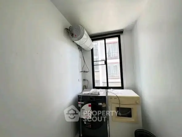 Compact laundry room with washing machine and dryer in a bright apartment.