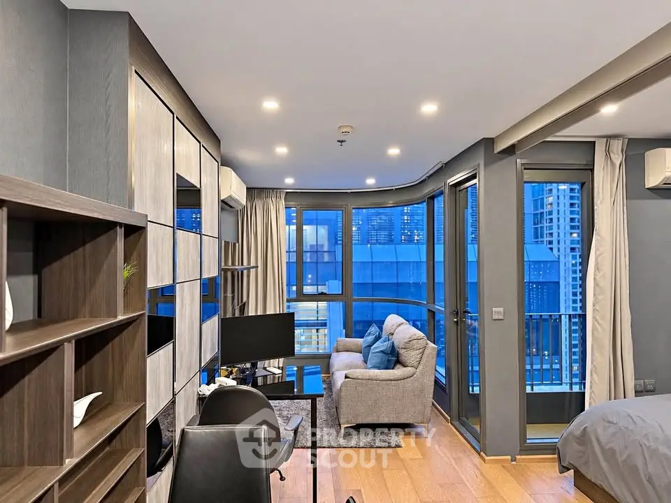 Modern living room with city view, featuring stylish furniture and large windows for natural light.