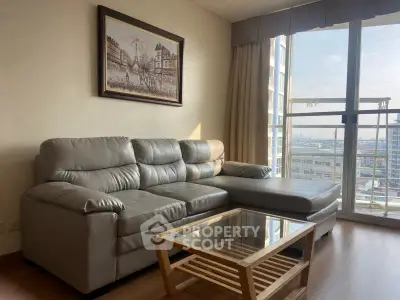 Modern living room with leather sofa and city view from large window