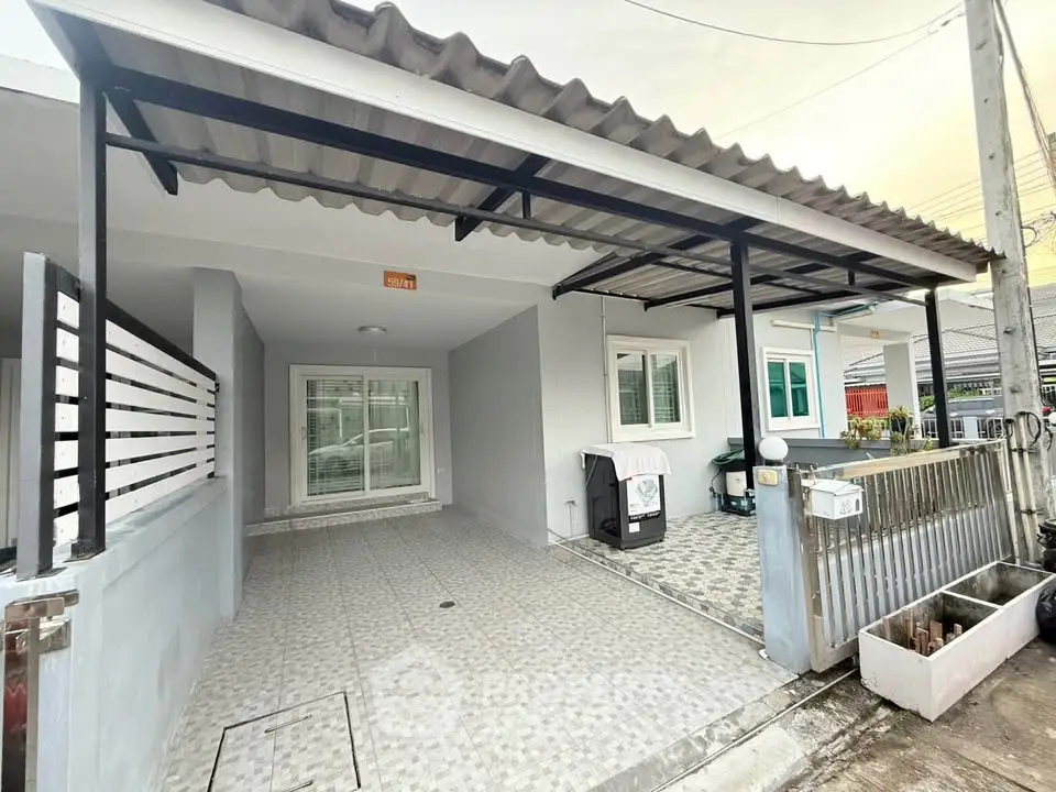 Charming single-story home with covered carport and modern exterior design.