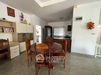 Spacious dining area with wooden furniture and modern kitchen in open layout