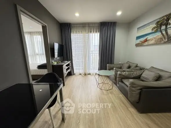 Modern living room with sleek furniture and large windows in a stylish apartment.