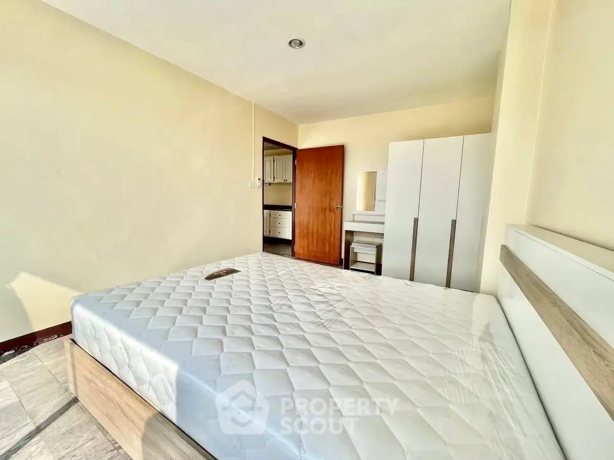 Bright and airy bedroom with modern furnishings and ample natural light.