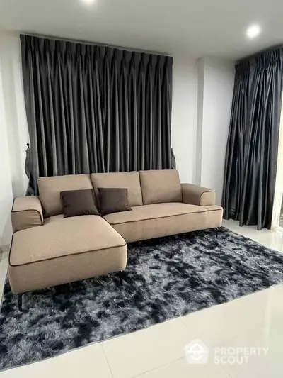 Modern living room with stylish sofa and plush rug, perfect for contemporary homes.