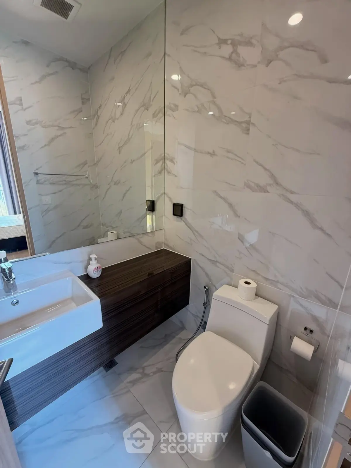 Modern bathroom with sleek fixtures and marble tiles