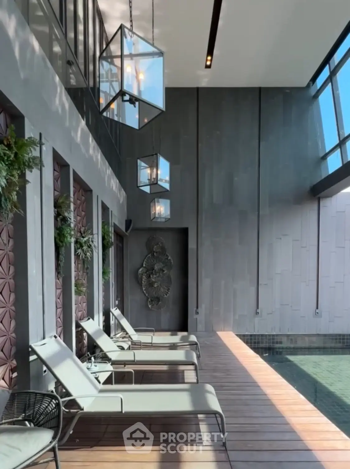 Luxurious indoor pool area with modern design and elegant lounge chairs