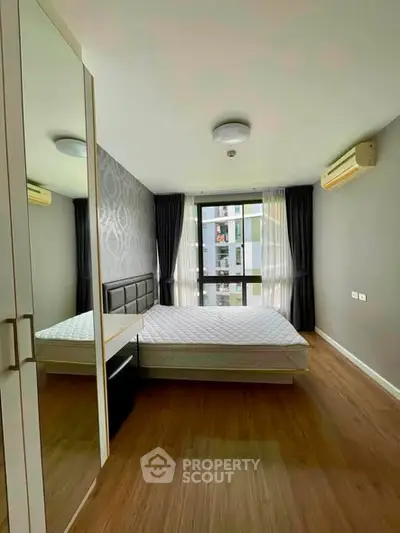 Modern bedroom with large window and stylish decor in urban apartment