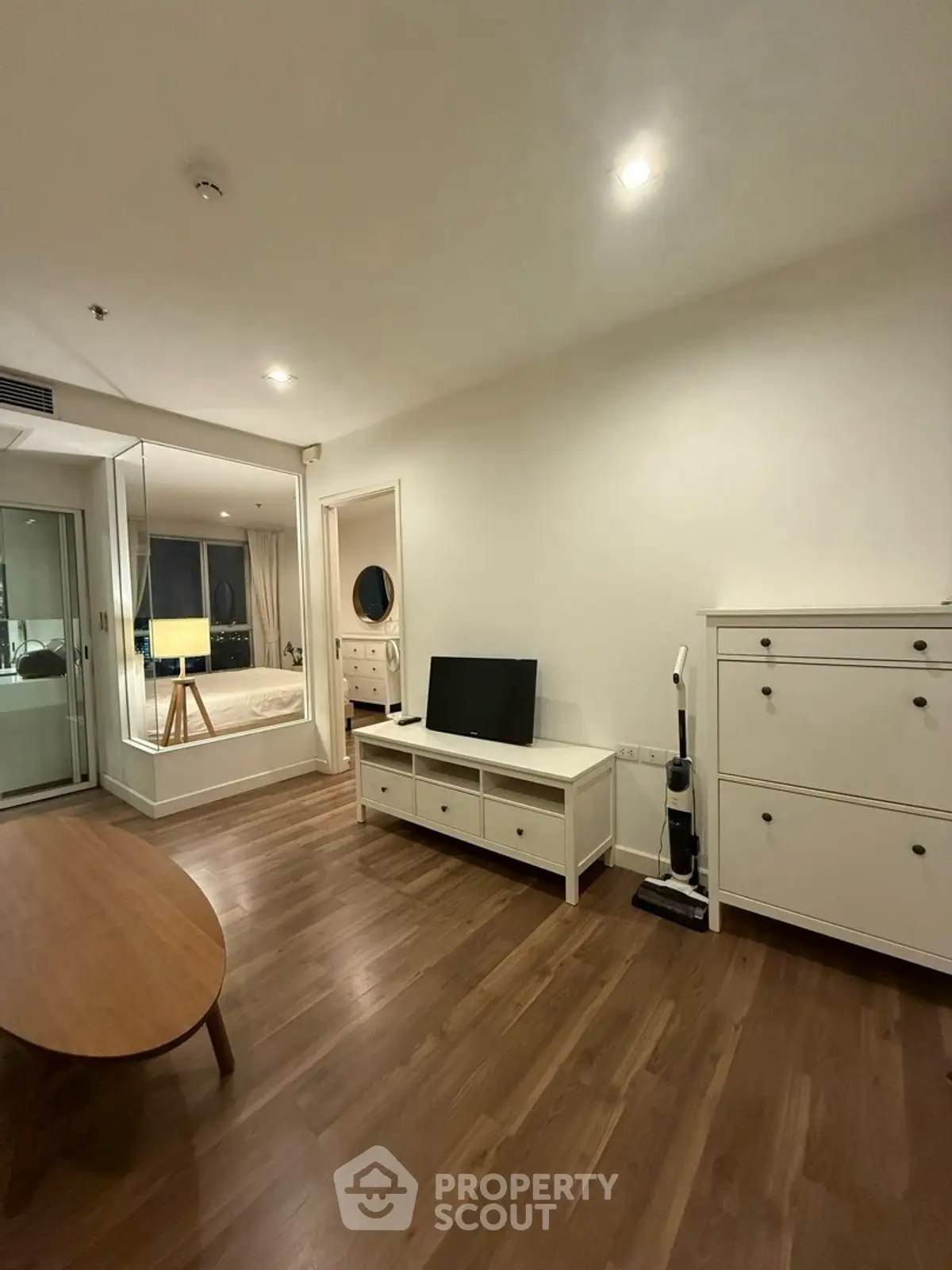Modern living room with wooden flooring and sleek furniture