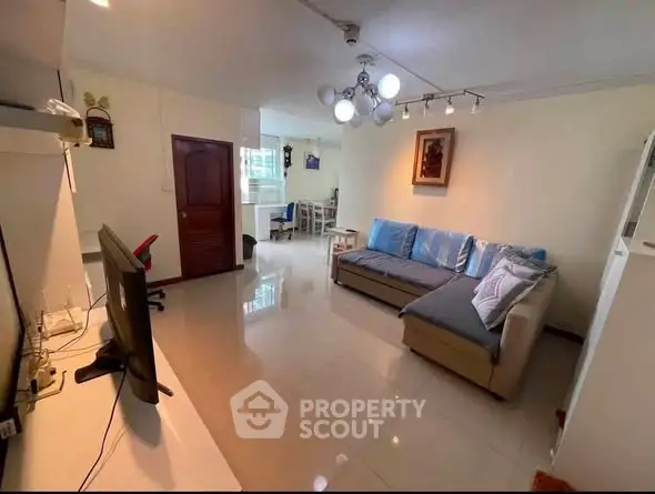 Spacious living room with modern decor and ample natural light, perfect for relaxation and entertainment.